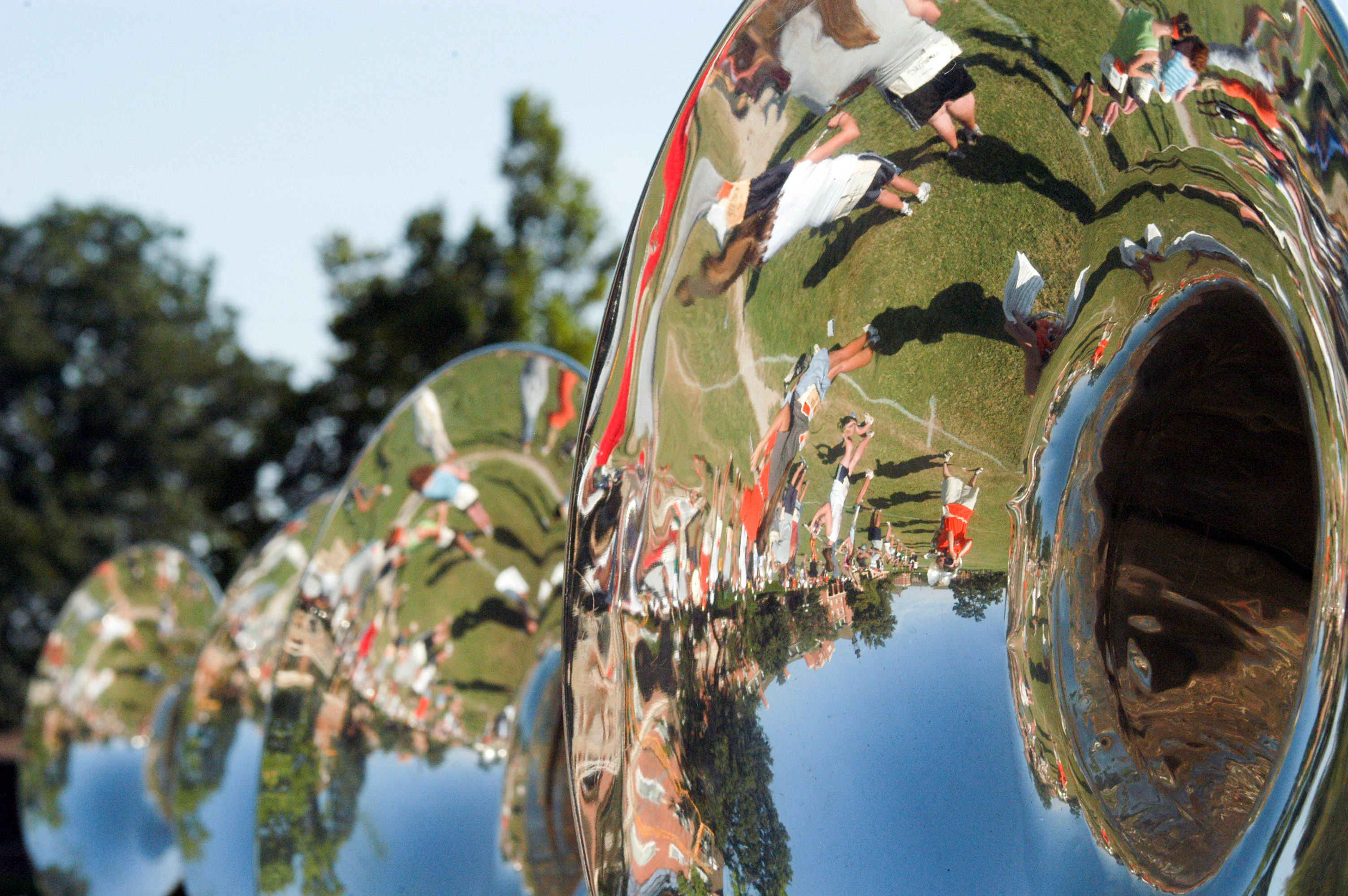 Reflective sousaphone showing a marching band on the field